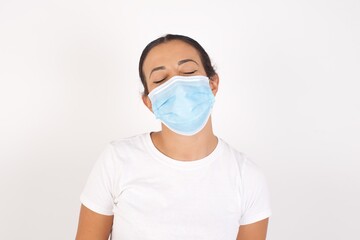 Young arab woman wearing medical mask standing over isolated white background very happy and excited about new plans.