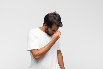 young latin handsome man raising palm to forehead thinking oops, after making a stupid mistake or...