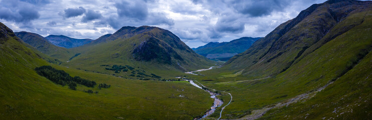 Fototapeta na wymiar aerial panorama image of glen etive in the argyll region of the highlands of scotland during a dark stormy evening in summer