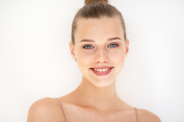 Portrait of beautiful woman with clean skin, youth concept, beauty treatment. Cheerful teen girl, beauty female face happy smiling and looking at camera over white background