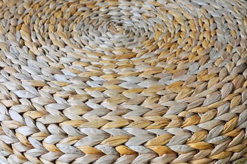 Abstract textured background from organic reeds. Ethnic pattern backdrop. Wicker surface made of natural material, selective focus.
