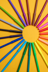 Colored markers on orange background