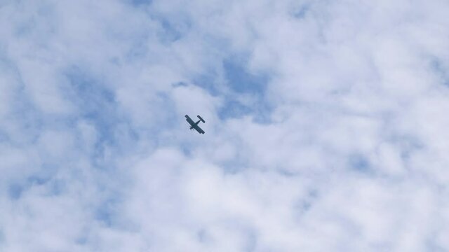 Military plane in the sky. Scenic footage with biplane in blue cloadscape and copy space - High Quality Full HD video.