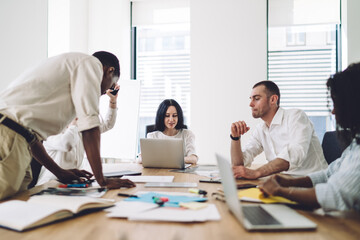 Colleagues reading papers while brainstorming