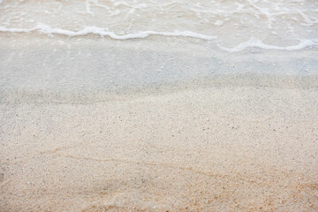 Soft beautiful ocean wave on sandy beach. Background. Sea wave on white sandy beach. Travel natural background. Soft focus