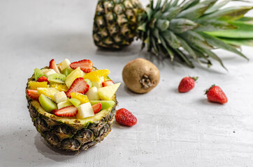 fruit salad in pineapple with different fruits.