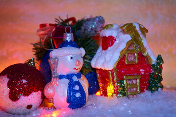 christmas night snowman and house,Christmas card snowman toy with a house in the snow