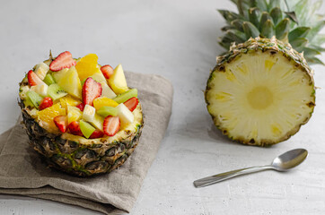 fruit salad in pineapple with different fruits.