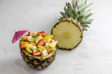 fruit salad in pineapple with different fruits.