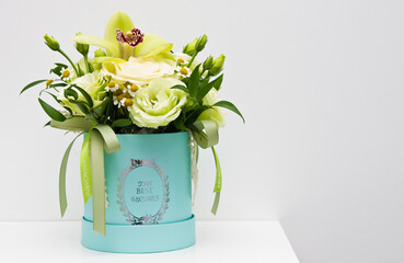 Elegant bouquet in blue flower box on white background