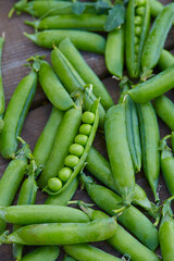 fresh green peas on wooden surface