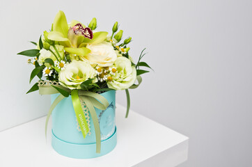 Elegant bouquet in blue flower box on white background