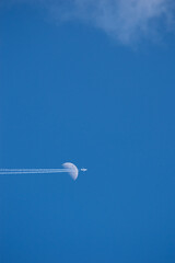 airplane crossing the moon