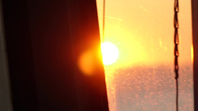 ViewView from the ship's illuminator to the sea roadstead at sunset.