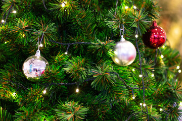 Decorated Christmas tree on blurred, sparkling and fairy background with color ball