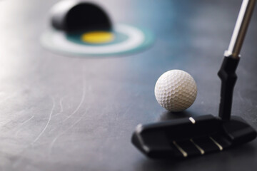 Sport and healthy lifestyle. Mini golf. White golf ball and set for minigolf on the table. Sports background with golf concept.