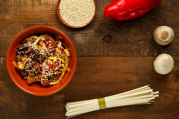 Udon with chicken and mushrooms on a large plate.