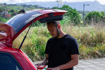 Latin man pulls triangles out of his car