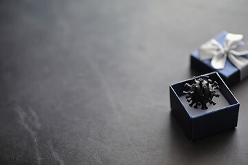 The concept of the world coronavirus pandemic. The geographical location of the virus. China flag and virus model and gift box.