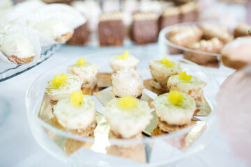 Close up of tasty turkish desserts with whipped cream and lemon curd, simple recipe. Delicious sweet nutricion on celebration party. Table catering with yummy food. Concept of calories and dieting.