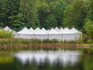 A view of the white tents by the water