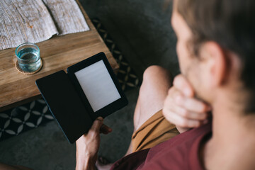 Anonymous man using e book in cafe