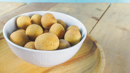 Close up longan of fruit on a white bowl