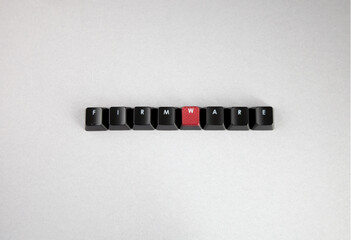 FIRMWARE spelled out with computer keyboard keys, black and red keys, isolated