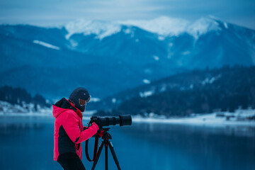 Fototapeta premium Landscape photographer taking images at a scenic mountain destination. 