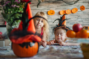 children waiting for holiday halloween with beautiful pumpkin on table and decorated room