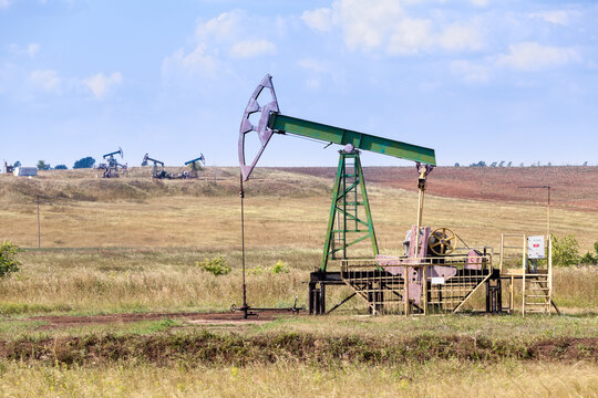 Oil and gas pump in action, industrial fuel oilwell, oilfield