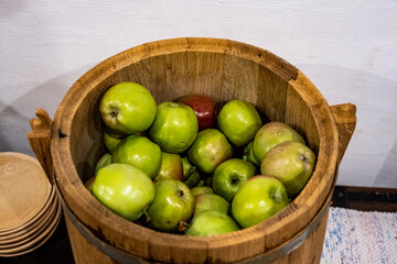 green apples in a wooden light brown bucket