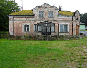 uninhabited, ruined abandoned house on the street in church lipowiec in mazovia, poland