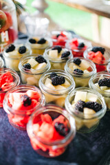 Close up of beautiful glassware full with sliced fresh fruits and berries, watermelon, blackberry, pineapple. Luxury catering on vegetarian party. Simple recipe. Concept of alcohol free  celebration.