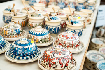 Fototapeta na wymiar Happy colorful ceramics. Traditional Romanian handmade ceramics market at the potters fair from Sibiu, Romania