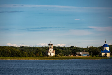 vintage wooden complex with temple watchtower and fortress wall against blue sky