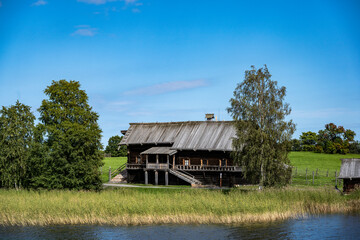 vintage wooden complex with temple watchtower and fortress wall against blue sky