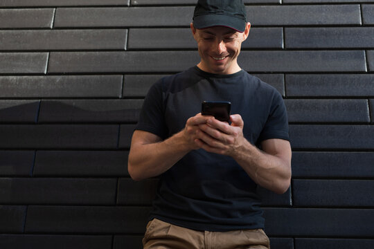 A man looks into a smartphone - Powered by Adobe