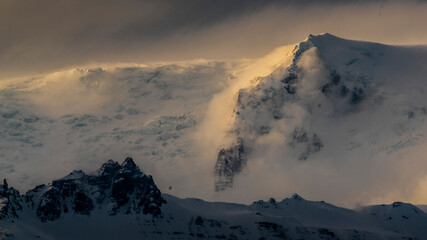 Fototapeta na wymiar sunset over the mountains with snow