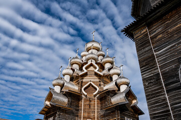 vintage wooden complex with temple watchtower and fortress wall against blue sky