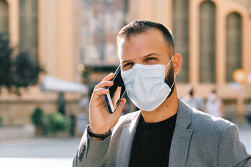 adult man in grey casual suit with mask and social distance - coronavirus concept