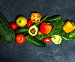Various fruits and vegetables for a healthy diet, top view on a dark background.