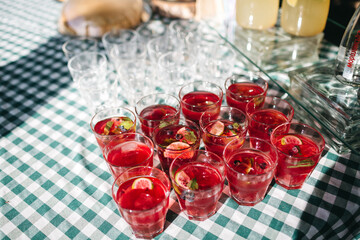 Top view of delicious alcohol free drinks on table with cozy homey tablecloth. Homemade cocktails for small birthday party in quarantine period. Vegetarian celebration. Concept of health and diet.