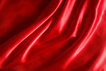 Naklejka na ściany i meble Red satin or silk fabric as background.