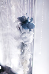 Close up of pale blue wedding decoration and rhinestones on wall. Interior design element on white background. Tender light beautiful restaurant adornment. Concept of modern trends, style and beauty.