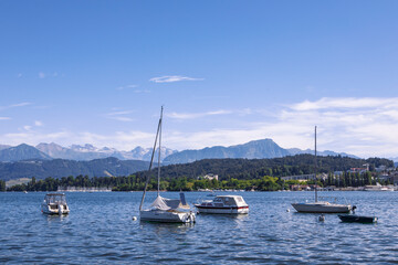 Fototapeta na wymiar Panorama of Lake Lucerne, yachts in the water, view on Alps, summer day. Switzerland