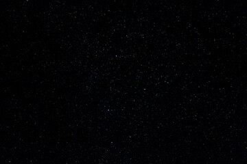 Starry sky and Summer meadow with trees. Summer night. The milky way over the field.