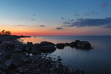 Rocky shore and peninsula of Baltic sea at sunset. Nordic minimalistic wilderness.