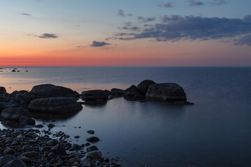 Fototapeta na wymiar Rocky shore and peninsula of Baltic sea at sunset. Nordic minimalistic wilderness.
