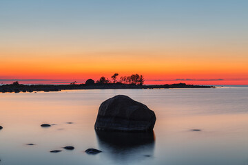 Fototapeta na wymiar Rocky shore and peninsula of Baltic sea at sunset. Nordic minimalistic wilderness.
